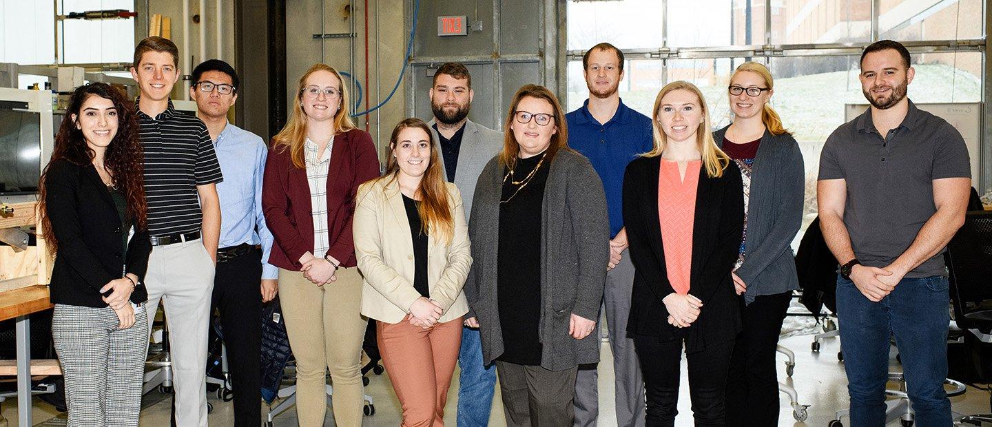 A group of people in a lab, posing for a photo.